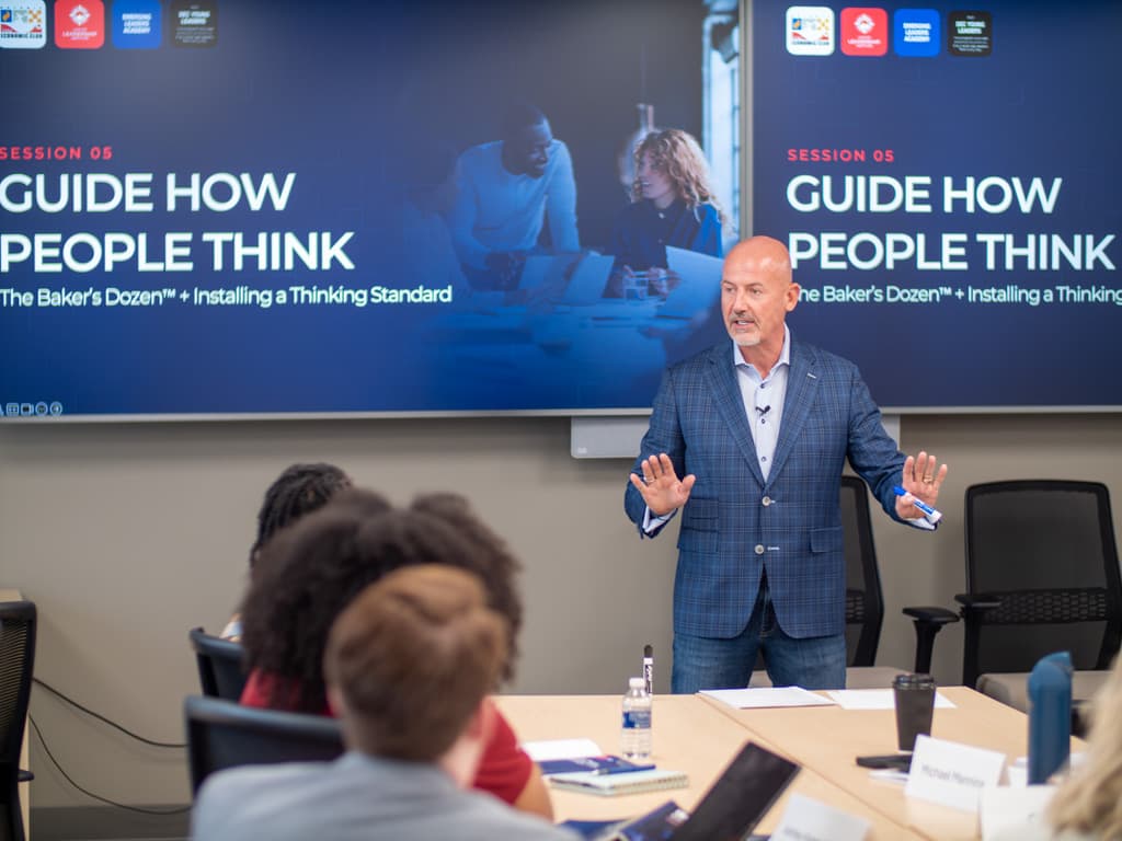 Steve Lowisz leading a DEC session in front of the Guide How People Think slide