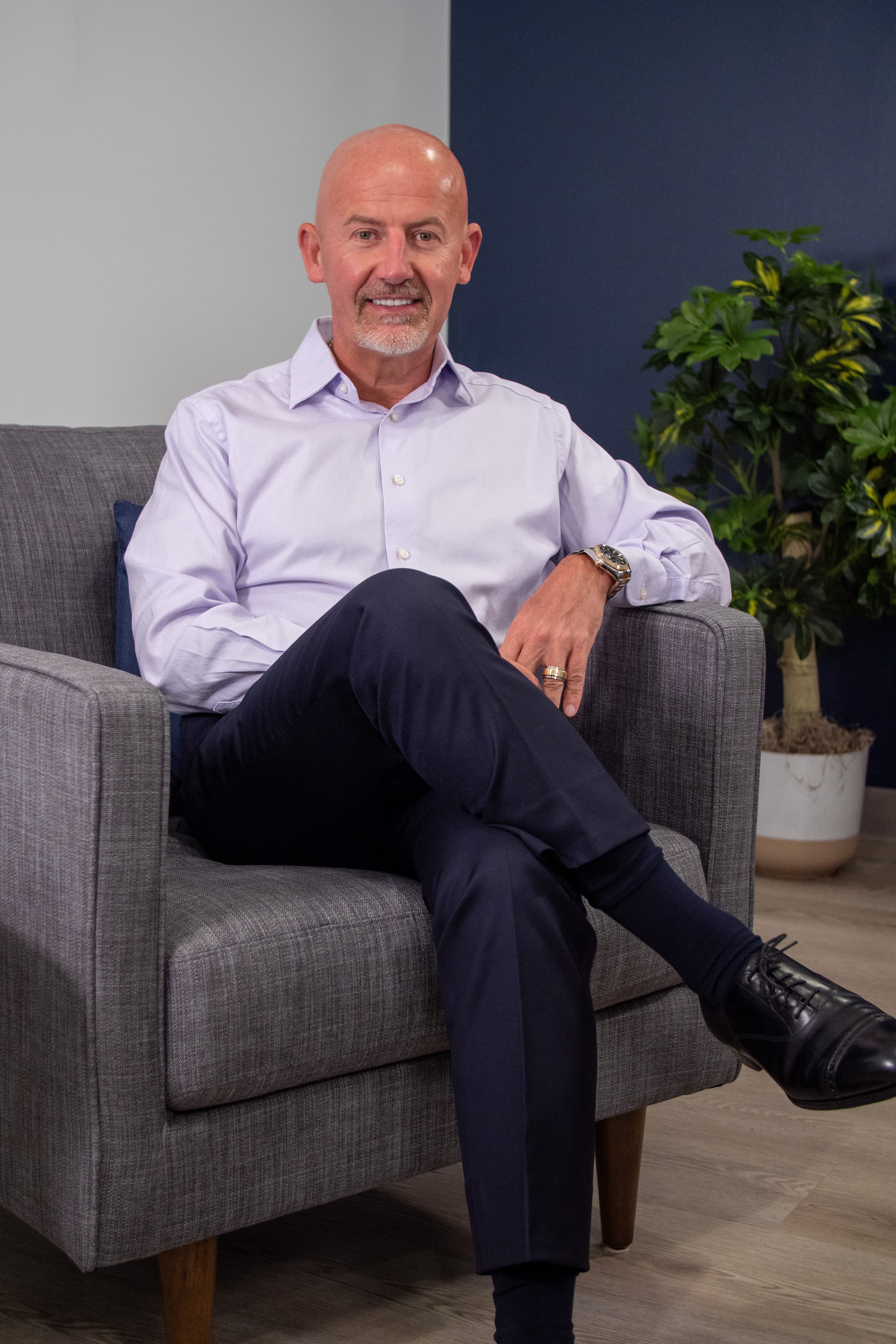 Steve Lowisz seated in a gray armchair